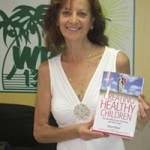 A woman holding up a book about functional health and thyroid.