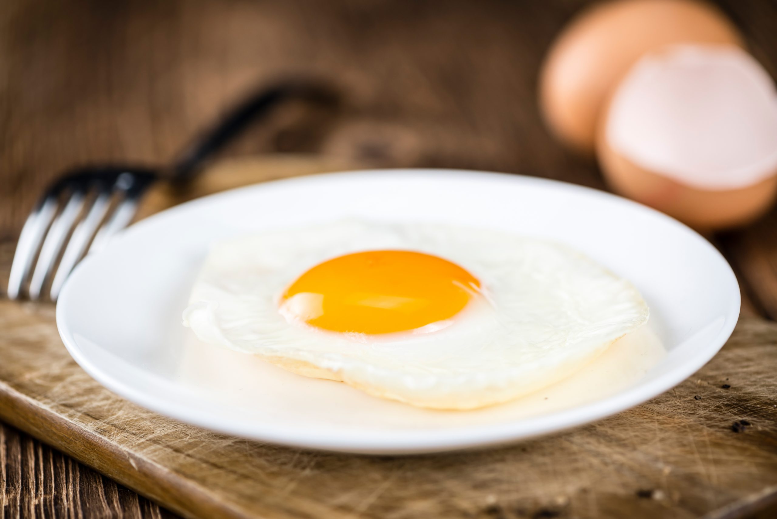 An egg sits on a plate.