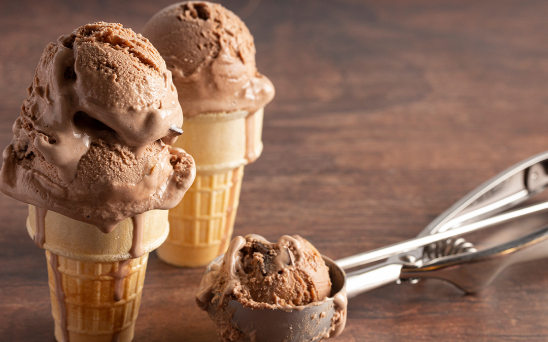 Chocolate vegan ice cream cones with scoops on a wooden table. Dr